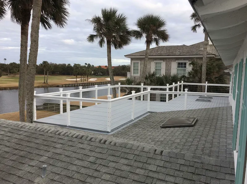 Completed rooftop deck carpentry with white cable railing overlooking the golf course in Ponte Vedra Beach, FL