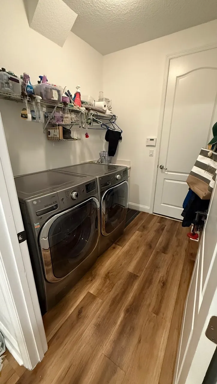 Laundry room remodel before — wire shelving over silver front-load washers by All Beaches Remodeling and Repair