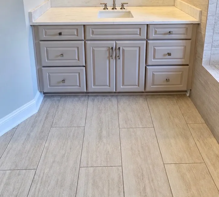 Master bathroom vanity remodel after — gray raised-panel vanity with white quartz countertop by All Beaches Remodeling and Repair